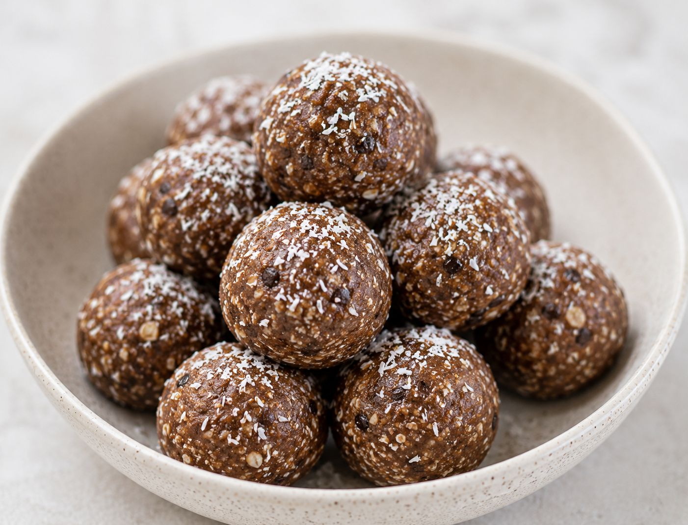 Σπιτικά energy balls με κακάο και ινδοκάρυδο σε λευκό πιάτο